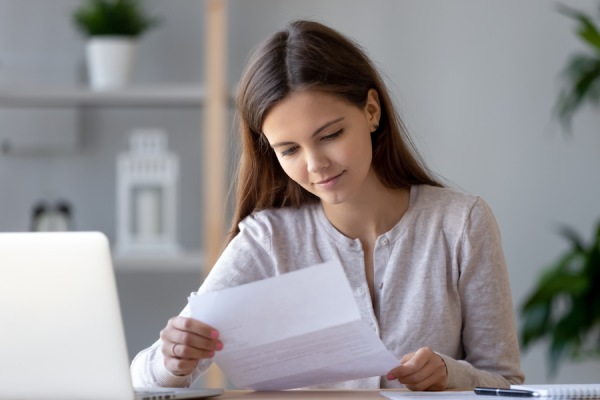 Smiling young woman doing paperwork 