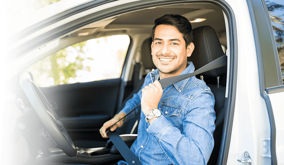 A man prepares to take a driving test, seated in the driver's seat of his car at DrivingQuest.