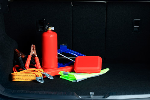 Open car trunk displaying tools and supplies, highlighting the importance of safety during Texas fall driving conditions.