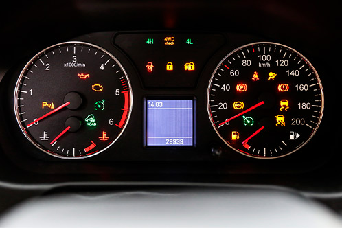A detailed dashboard filled with multiple gauges, illustrating key safety technologies for novice drivers.