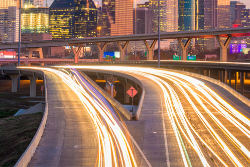 Houston, Texas, USA downtown city skyline and highway.