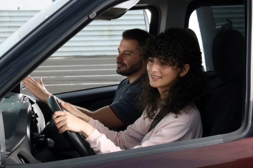 Driving school. Student during lesson with driving instructor in car